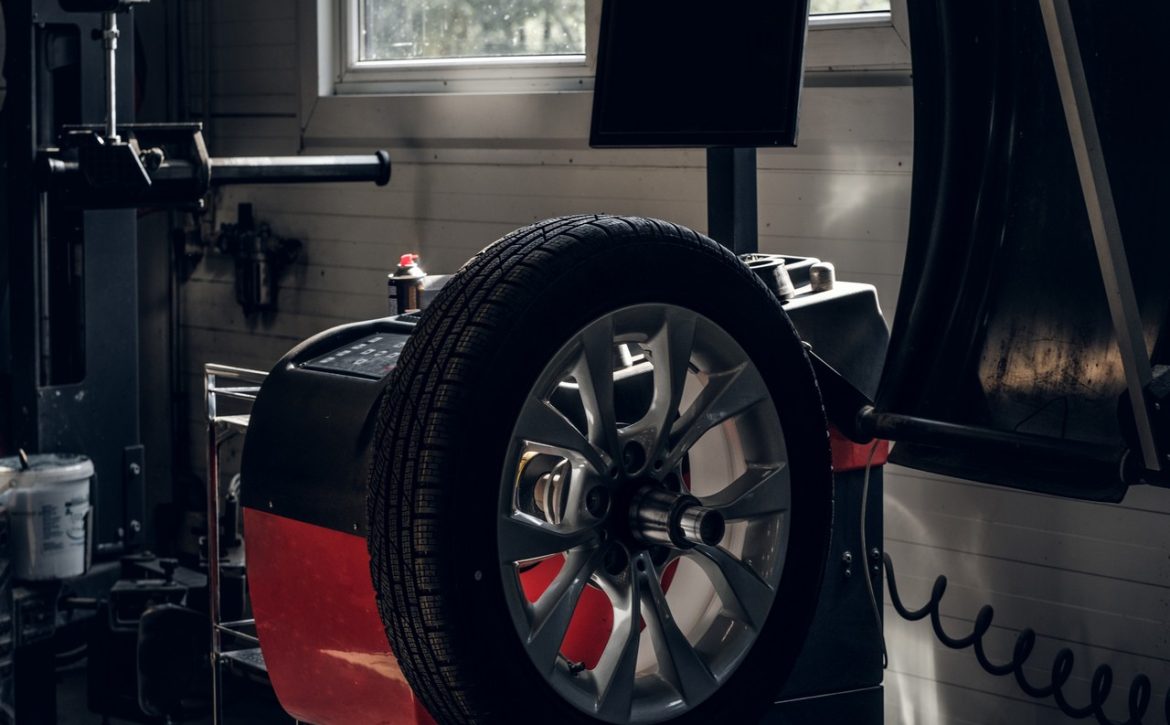 Parts of broken red car in workshop